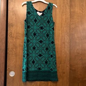 Dark green with black details around the whole dress with short sleeves